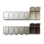 Zwei geöffnete DOSE & DONE Wochen-Pillendosen in creme und braun mit beschrifteten Tagesfächern auf transparentem Hintergrund.